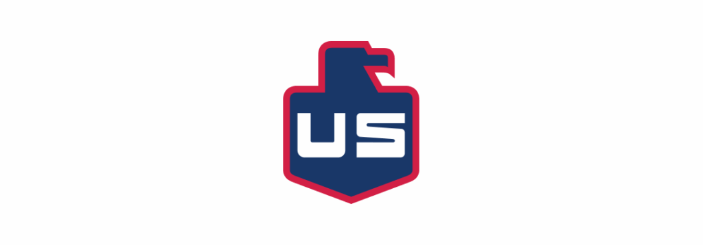 A stylized blue shield logo with a red outline features a simplified eagle head on top and bold white letters US in the center.